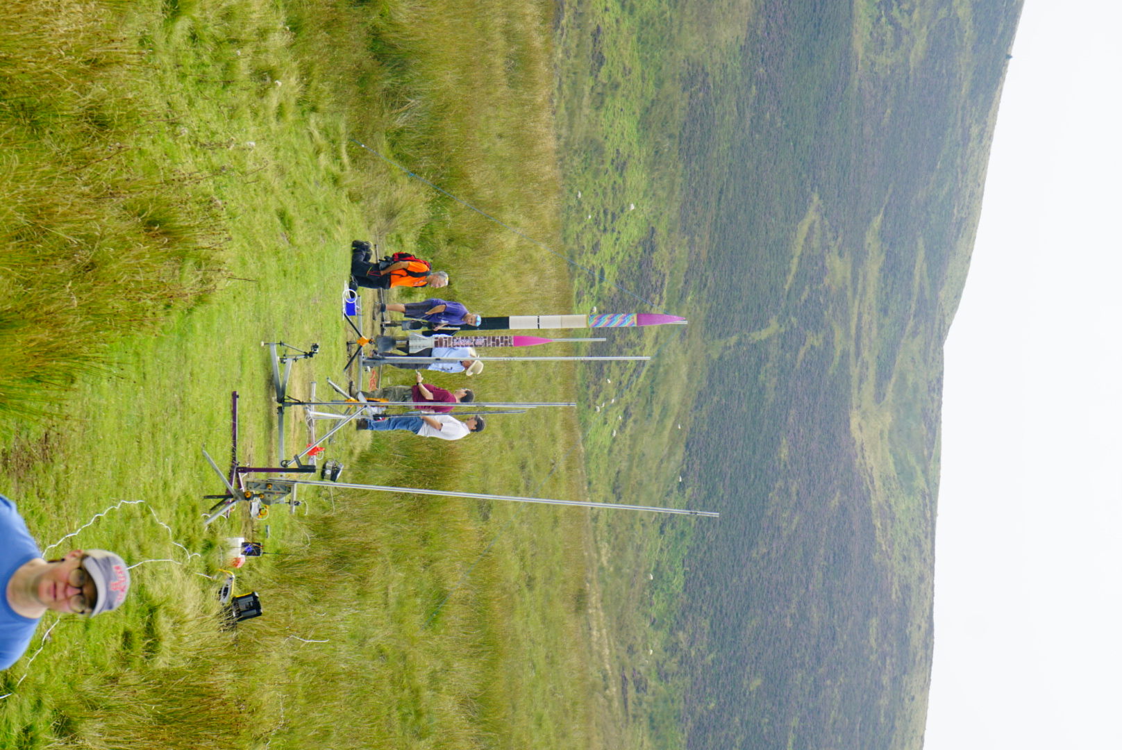 A row of launch rails and rockets in a remote grassland launch area