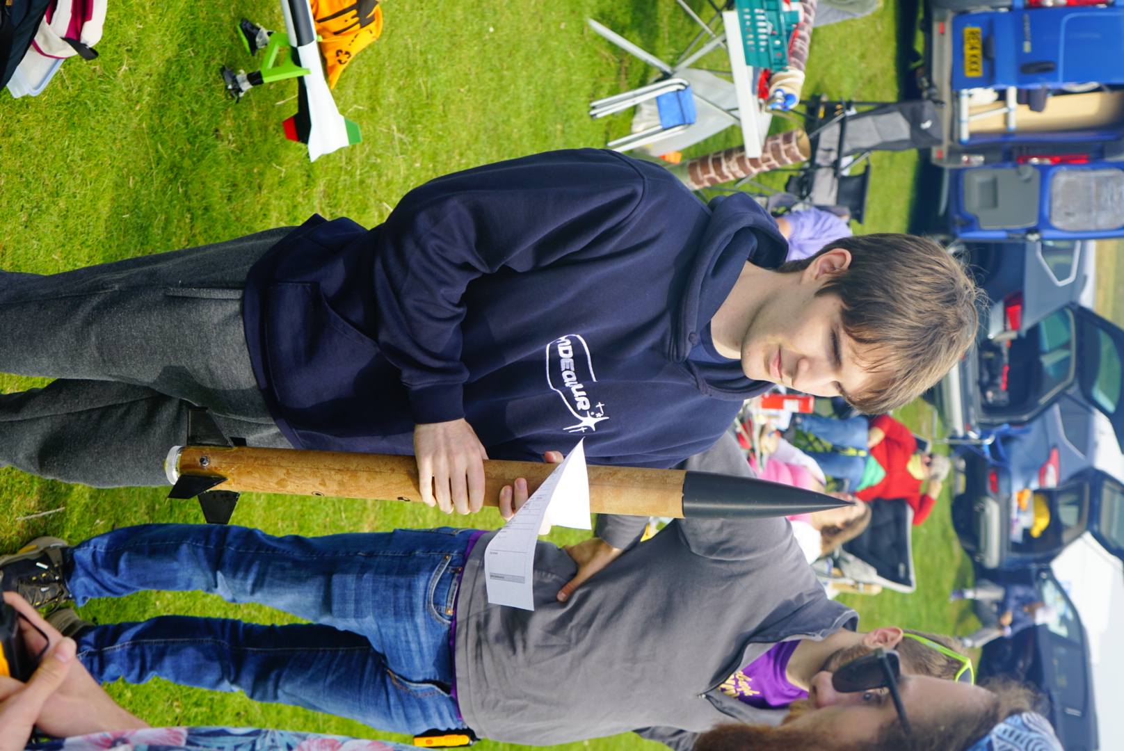 An Endeavour member holding a rocket while reviewing a checklist