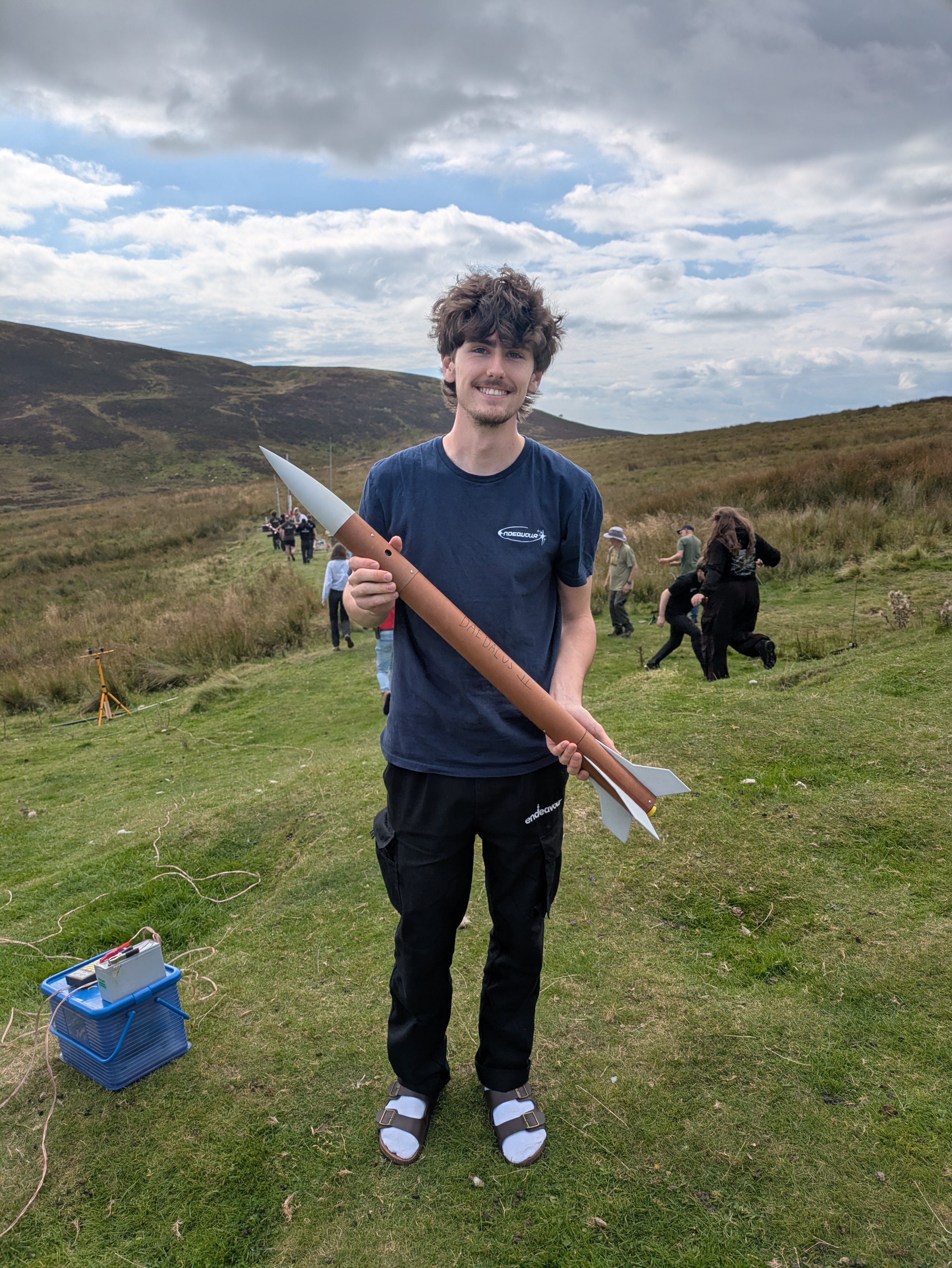 An Endeavour member holding a rocket at the launch field