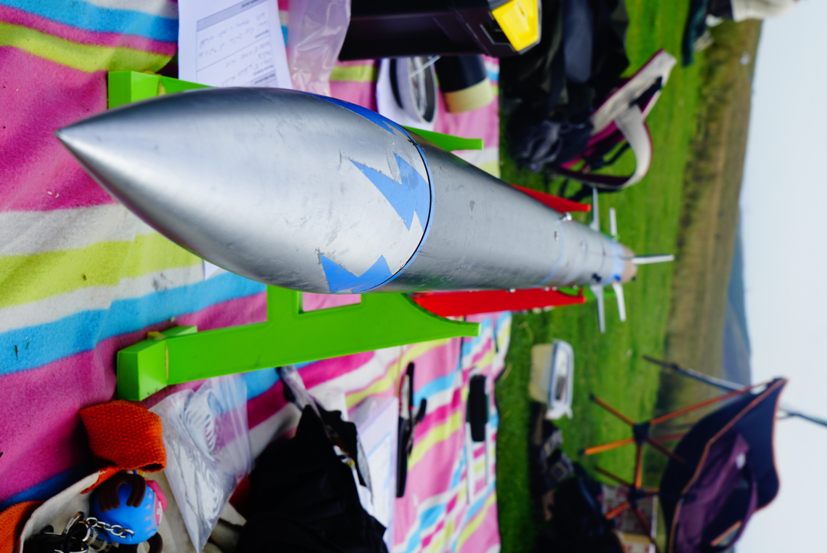 Close-up of a silver rocket airframe and nose cone