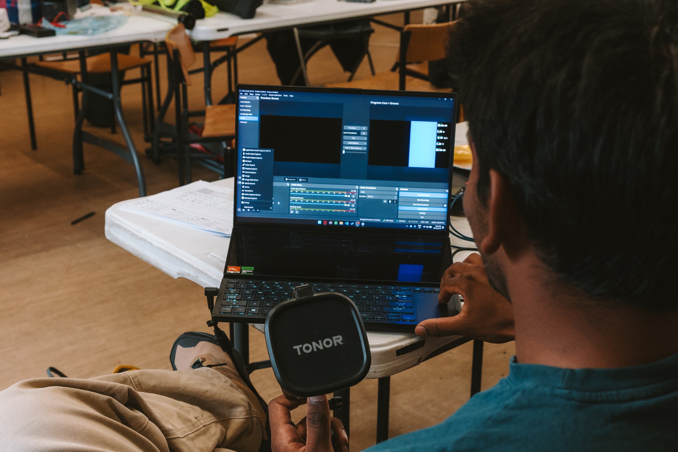 An Endeavour member configuring the live video system on a laptop