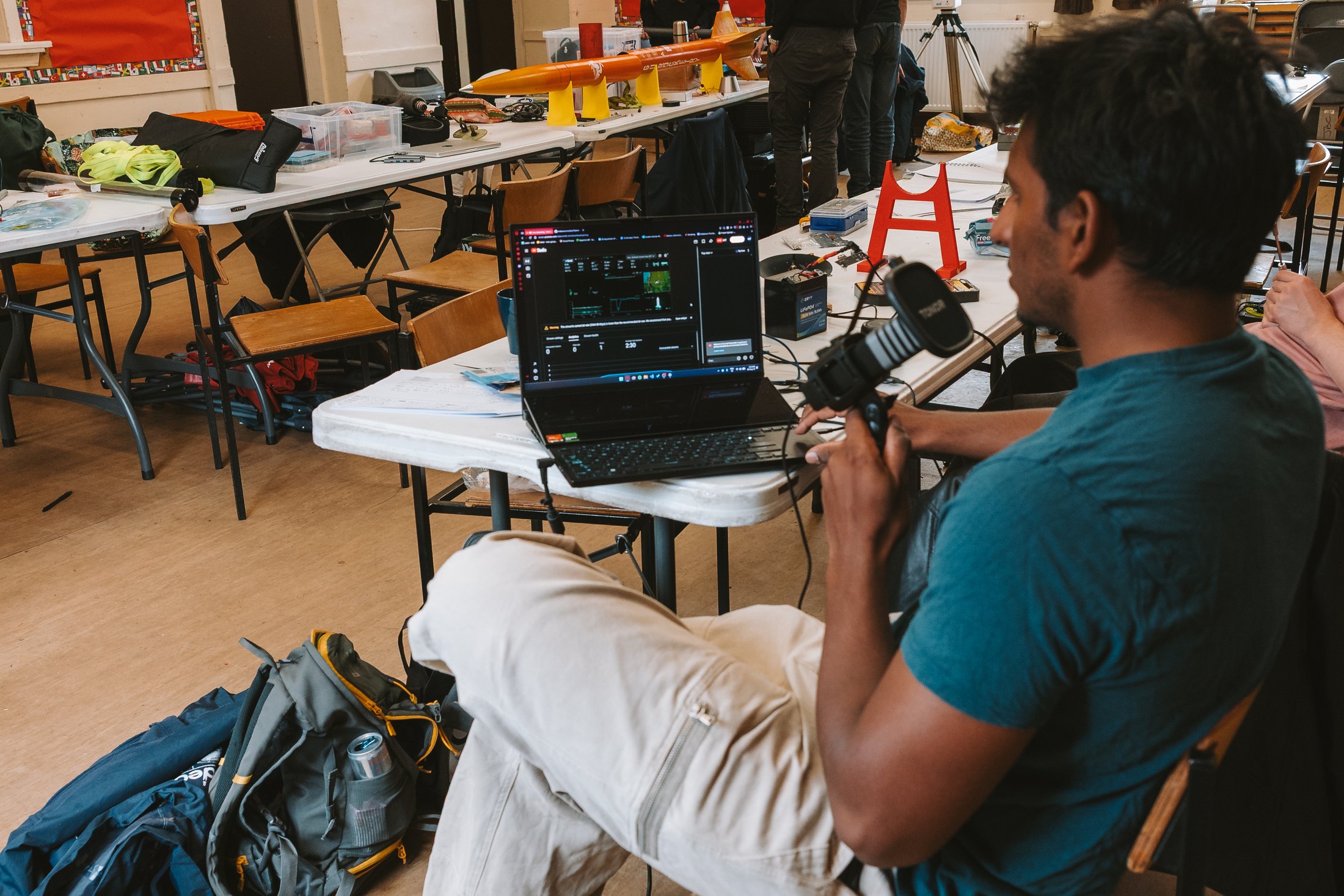 An Endeavour member operating live video systems beside flight hardware